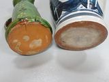two vases sitting next to each other on a table