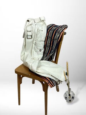 an image of a white leather jacket and pants on a chair