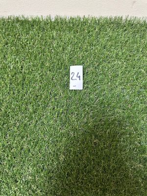 artificial grass with a number 24 on it in front of a white wall