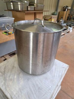 a large metal pot sitting on top of a pallet
