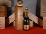 une bouteille de champagne posée sur une table à côté de caisses en bois