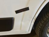 a close up of a white truck with a sticker on it