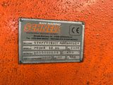 a metal plaque on the side of a red wall