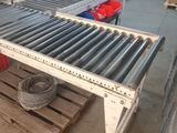 an image of a conveyor belt in a warehouse with pallets and boxes