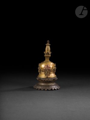 a gold statue of a buddha on a pedestal with a black background