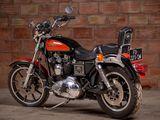 a motorcycle that is parked in front of a brick wall