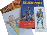 several books on a white background with a drawing of a man in a cowboy hat