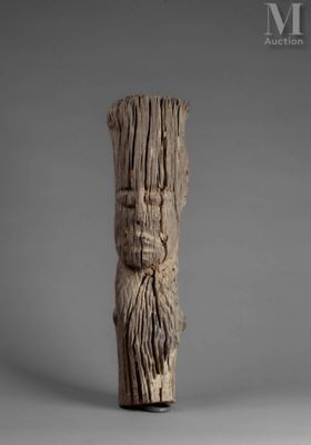 une image représentant un morceau de bois sur lequel est sculpté un visage