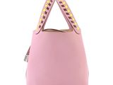 a pink handbag with studded handles on a white background