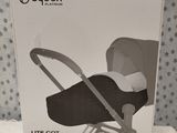 the box of a baby stroller is open on a bed