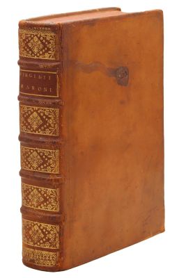 a brown leather book with gold trimming on the front