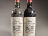 two bottles of wine sitting next to each other on a table