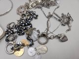 a pile of silver and black jewelry on a table