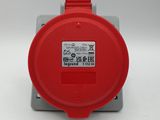 une image montrant un gros plan d'un appareil électronique rouge posé sur une surface blanche