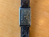 an image of a wrist watch on a wooden table