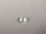 a close up of a white diamond sitting on top of a white surface