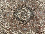 a close up of a large oriental rug on a wooden floor