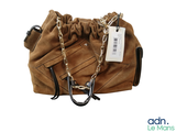 a brown purse with a chain and a tag on it