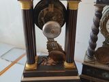 two clocks that are sitting next to each other on a table