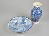 a blue and white bowl and a blue and white vase on a table