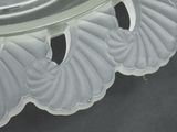 a close up of a glass plate with shells on it
