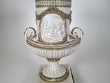 a white and gold vase with a picture on it