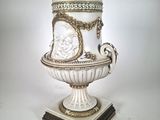 a white vase that is sitting on top of a table