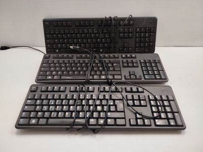 two keyboards sitting on a table with wires attached to them