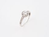 a close up of a diamond ring on a white background
