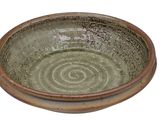 a green bowl with a spiral design on it