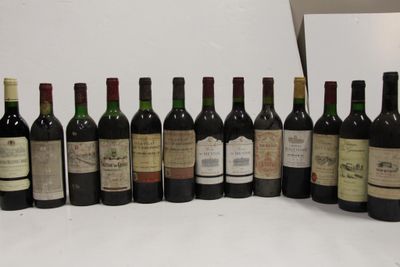 several bottles of wine are lined up on a white surface