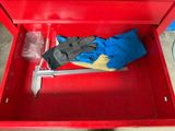 a red tool box with a pair of gloves in it