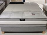 a bed that has a mattress on it in a store