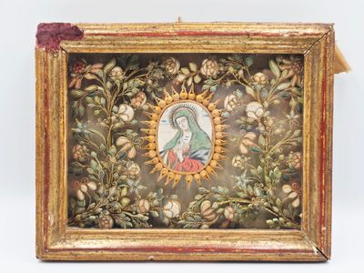 an old picture of a woman in a frame with flowers and leaves
