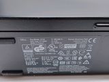 the back side of a laptop with a battery on top of it