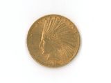 a gold coin on a white surface with a white background