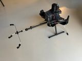 a small black drone sitting on a white floor