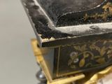 a black and gold box with a black and gold design on it