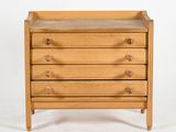 a small wooden dresser with three drawers on top of it