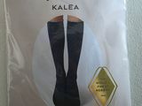the packaging of a pair of black knee high socks on a white surface