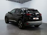 the rear end of a black suv parked in a garage