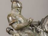 a statue of a man riding a horse with a sword in his hand