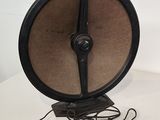 a black and brown fan sitting on a white table
