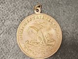 an image of a gold medal with a ship on it