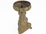 an antique brass candle holder on a white background