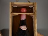 a bottle of wine in a wooden box on a table