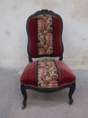 a red and black chair with a floral pattern on it
