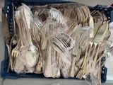 many forks and spoons in a basket on the table