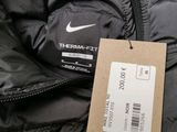 a black jacket with a white nike logo on it