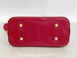 a red purse with gold hardware on the front